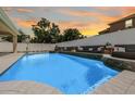 Inviting in-ground pool featuring waterfall accents and bench seating, perfect for relaxation and outdoor enjoyment at 14718 Rocky Brook Dr, Tampa, FL 33625