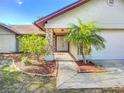 Charming single-story home with stone accents, mature landscaping, and a two-car garage at 1623 Carter Oaks Dr, Valrico, FL 33596