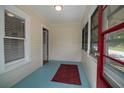 Inviting enclosed porch with blue floors and a red accent rug, perfect for relaxing at 1716 11Th N Ave, St Petersburg, FL 33713