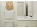 Well-lit bathroom featuring a marble countertop and decorative wall hanging at 18468 Serene Lake Loop, Lutz, FL 33548
