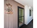 Welcoming entryway featuring a security door, neutral decor, and a charming wall decoration at 19111 Vista Bay Dr # 603, Indian Shores, FL 33785