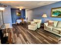 Living room featuring luxury vinyl plank floors and bright blue walls at 2020 World Parkway Blvd # 14, Clearwater, FL 33763