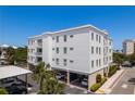 Well-maintained condo building showcasing balconies and covered parking for residents and guests at 231 2Nd S St # 201, Safety Harbor, FL 34695