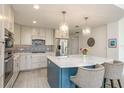 Modern kitchen with a stylish island, stainless steel appliances, and decorative backsplash at 231 2Nd S St # 201, Safety Harbor, FL 34695