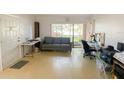 Bright living room with neutral tile flooring, a sliding glass door, and a comfortable seating area at 2643 Pine Ridge S Way # A1, Palm Harbor, FL 34684