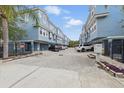 View of the neighborhood with brick paver driveway, and multiple parked cars at 3111 W De Leon St # 8, Tampa, FL 33609