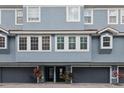 Two-story exterior with gray garage doors and light blue siding with white trim at 3111 W De Leon St # 8, Tampa, FL 33609