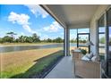 Relaxing screened porch featuring comfortable seating and scenic lake views at 33030 Major Oak Dr, Wesley Chapel, FL 33545