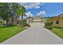 Charming single-story home with a two-car garage and well-manicured landscaping at 3315 Granite Ridge Loop, Land O Lakes, FL 34638