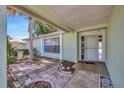 Welcoming front porch area with decorative brickwork and a light green exterior at 3414 Rankin Dr, New Port Richey, FL 34655