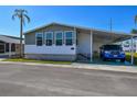 Charming manufactured home featuring a covered carport and well-maintained landscaping at 34506 Rose N Dr, Pinellas Park, FL 33781