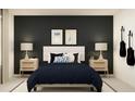 Stylish bedroom with accent wall, white bed, and modern nightstands creates a serene space at 36046 Joseph Blake St, Zephyrhills, FL 33541