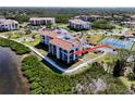 Gorgeous condo building with balconies overlooking the water, with mature landscaping and tennis courts at 433 Mariner Dr # 433, Tarpon Springs, FL 34689