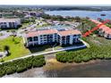 Beautiful condo building with balconies, terracotta tile roof, and situated on a waterfront property at 433 Mariner Dr # 433, Tarpon Springs, FL 34689