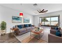 Bright living room featuring a modern ceiling fan, comfortable seating, and access to a screened lanai at 4862 Pond Ridge Dr, Riverview, FL 33578