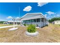 A well-maintained front yard with decorative landscaping enhances the curb appeal of this charming home at 5646 Cheyenne St, Zephyrhills, FL 33542