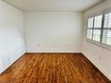 Comfortable bedroom with wood-look flooring, natural light from shuttered window at 5660 80Th N St # C101, St Petersburg, FL 33709