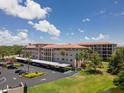 Exterior of Golfview Condominiums featuring covered parking, lush landscaping, and building architecture at 6150 Gulfport S Blvd # 306, Gulfport, FL 33707
