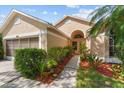 Charming home exterior showcasing a well-manicured lawn, tasteful landscaping, and a welcoming walkway at 7235 Sharpsburg Blvd, New Port Richey, FL 34653