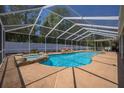 Sparkling pool with attached spa and screened enclosure, perfect for outdoor entertaining and relaxation at 7285 Nightwalker Rd, Weeki Wachee, FL 34613