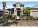 Inviting front entrance with stone accents, a decorative wreath, and well-maintained landscaping at 7911 Hampton Lake Dr, Tampa, FL 33647