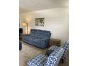 This comfortable living room features a plush sofa, stylish chairs and lighting, and neutral colored floors at 7951 58Th N Ave # 308, St Petersburg, FL 33709