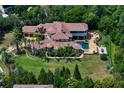 Captivating aerial view of a home with a pool, a charming terrace, and lush landscape at 1102 Merry Water Dr, Lutz, FL 33548