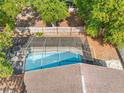 Aerial view of a screened-in backyard pool, enclosed by a wooden fence and lush foliage at 11318 Stoneybrook Path, Port Richey, FL 34668