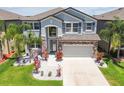 Beautiful two-story home with stone accents, a two-car garage, and manicured landscaping at 11416 Alachua Creek Ln, Riverview, FL 33579