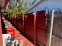 Backyard view of the exterior fence and deck of this single-Gathering home at 11600 Crystal Lake Dr, Port Richey, FL 34668