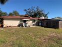 Spacious backyard showcasing the home's exterior and providing ample outdoor space at 11600 Crystal Lake Dr, Port Richey, FL 34668