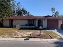 Charming single-story home featuring a well-kept lawn and a classic design at 11600 Crystal Lake Dr, Port Richey, FL 34668