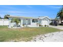 Charming single-story home featuring a well-maintained lawn, mature landscaping, and attached garage at 13401 Neptune Dr, Hudson, FL 34667