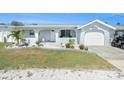 Charming single-story home with a lush green lawn and well-kept landscaping at 13401 Neptune Dr, Hudson, FL 34667