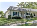Charming home featuring green shutters and well-maintained landscaping at 1430 Normandy Park Oaks Dr # 9, Clearwater, FL 33756