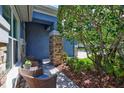 Inviting front porch showcasing two wicker chairs and a stone-accented pillar, perfect for relaxation at 14727 Tudor Chase Dr, Tampa, FL 33626