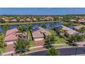 A high angle aerial shows attractive homes with well-manicured lawns in a quiet lakeside community at 16139 Coquina Bay Ln, Wimauma, FL 33598