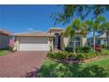 Charming curb appeal with manicured lawn and lush tropical landscaping framing this lovely single Gathering home at 16139 Coquina Bay Ln, Wimauma, FL 33598