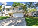 View of the home featuring light beige siding, a two-car garage, and a concrete driveway at 1735 Maryland Ne Ave, St Petersburg, FL 33703