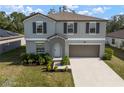 Charming two-story home featuring a well-maintained lawn and a two-car garage at 1823 Moon Cactus Ct, Ruskin, FL 33570