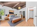 Cozy main bedroom features a high ceiling, wood beam and modern decor at 18816 Carr Dr, Lutz, FL 33559