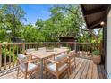 Outdoor dining area featuring a wooden table, chairs and lush surroundings at 18816 Carr Dr, Lutz, FL 33559