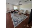 Spacious living room with hardwood floors, a patterned rug, and comfortable seating at 2310 Medford Ln, Brandon, FL 33511