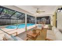 Enjoy outdoor living with a screened lanai overlooking the pool and featuring comfortable seating at 3212 W Villa Rosa St, Tampa, FL 33611