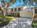Charming two-story home featuring a manicured lawn, welcoming front porch and attached two car garage at 3212 W Villa Rosa St, Tampa, FL 33611