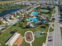 Stunning aerial view of community amenities including pool, playground, tennis and basketball courts, and lush green spaces at 32829 Woodthrush Way, Wesley Chapel, FL 33545