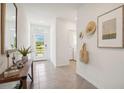 Inviting foyer with neutral tile flooring, ample natural light, and stylish decor at 33096 Osprey Peak Way, San Antonio, FL 33576