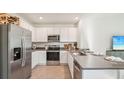 Modern kitchen featuring stainless steel appliances, sleek countertops, and ample cabinet space at 33096 Osprey Peak Way, San Antonio, FL 33576