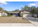 Charming one-story home featuring a well-maintained lawn, mature trees, and an attached two-car garage at 4034 Paddlewheel Dr, Brandon, FL 33511