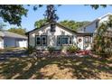 Inviting home exterior with a charming entrance, complemented by verdant landscaping and mature trees at 4334 18Th N St, St Petersburg, FL 33714